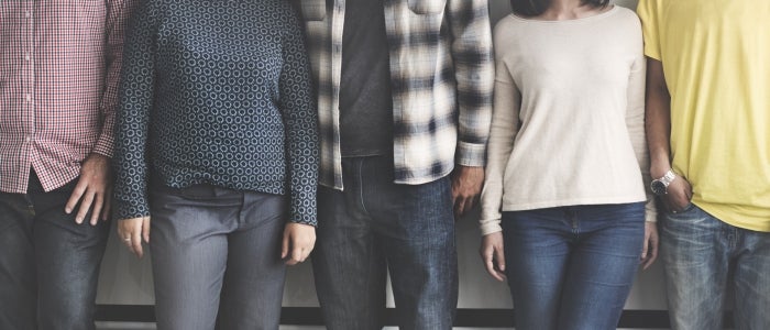 four people standing in a row