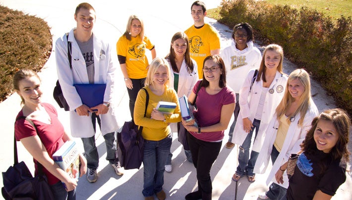 group of students smiling outside