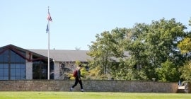 flagpole and student walking outside 