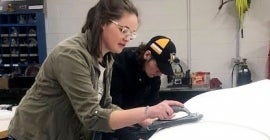 Pitt-Johnstown engineering students work on the concrete canoe