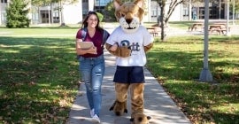 student and Pitt Johnstown mascot walking