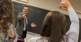 professor calling on student with raised hand 