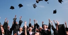 graduates tossing caps in air 