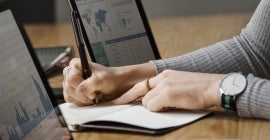 women writing with laptops open