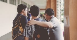 Three students in a hallway