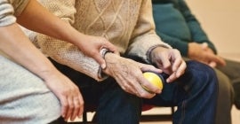 Elderly person holding a ball